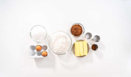 Flat lay. Ingredients in mixing bowls on the counter to bake chocolate cookies.の写真素材