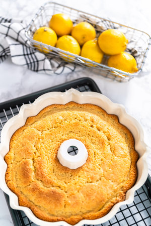 Cooling freshly baked a lemon pound cake on a cooling kitchen rack.