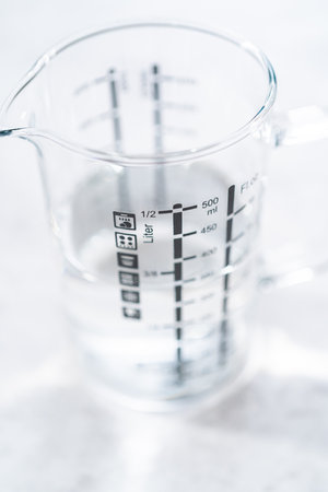 Baking soda and vinegar in glass containers for cleaning cast iron enameled braiser.の写真素材