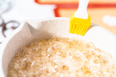 Caramelizing sugar in saucepan to make homemade lollipops.の写真素材