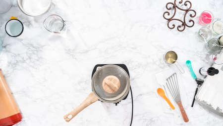 Flat lay. Caramelizing sugar in saucepan to make homemade lollipops.の写真素材