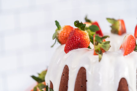 fresh strawberries. Red velvet bundt cake with cream cheese frosting garnished with fresh...