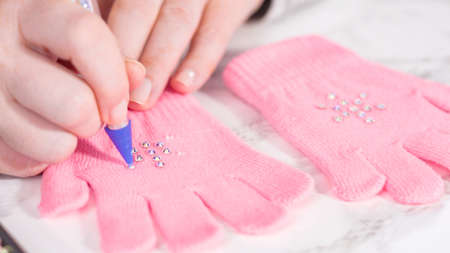 Rhinestone pink kids gloves with snowflake shapes.の写真素材