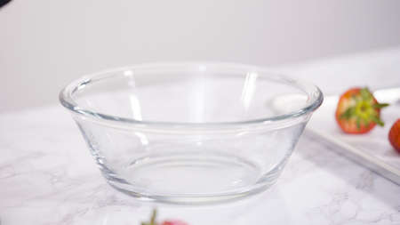 Step by step. Dipping organic strawberries into melted chocolate.の写真素材