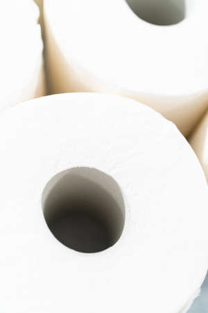 New white toilet paper rolls on a gray background.の写真素材