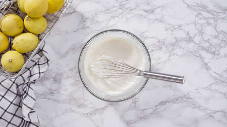 Step by step. Flat lay. Mixing ingredients into the batter for lemon pound cake.の写真素材
