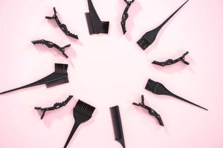 Flat lay. Hair color dying plastic brushes on a pink background.の写真素材