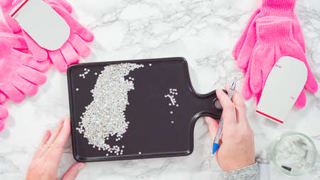 Flat lay. Rhinestone pink kids gloves with snowflake shapes.の写真素材