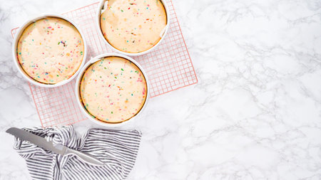 Flat lay. Step by step. Cooling freshly baked funfetti cake layers on a drying rack.