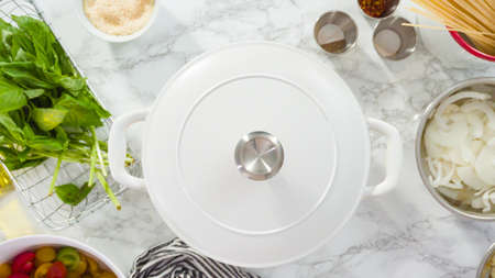 Flat lay. Step by step. Cooking on pot pasta recipe in an enameled cast iron dutch oven.の写真素材