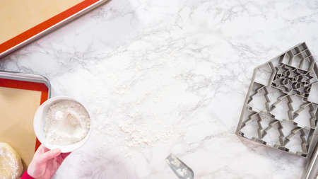 Flat lay. Rolling out sugar cookie dough to bake Christmas cookies.の写真素材