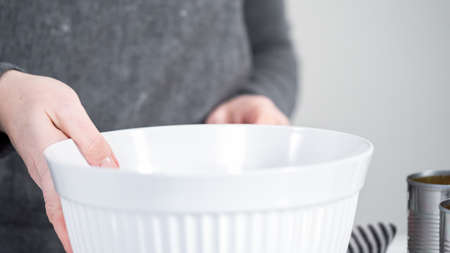 Openning canned white beans with can opener.の写真素材