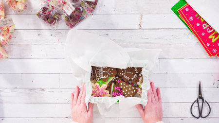 Flat lay. Step by step. Packaging homemade fudge and cookies into a Christmas gift box.