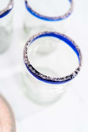 Garnishing edged of the glass with salt for frozen watermelon margarita.の写真素材