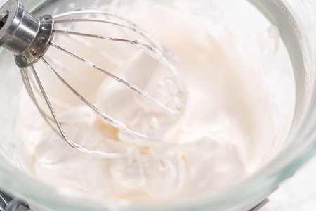 Making meringue in kitchen mixer to bake unicorn meringue cookies.の写真素材
