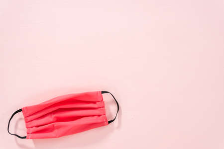 Homemade face masks for virus outbreak on a pink background.の写真素材