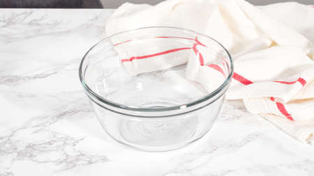 Step by step. Mixing ingredients in a glass mixing bowl to prepare bacon and cheese egg muffin.の写真素材