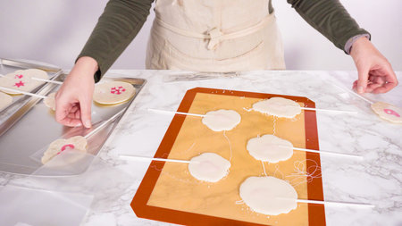 Peeling large homemade lollipops from silicone mat.
