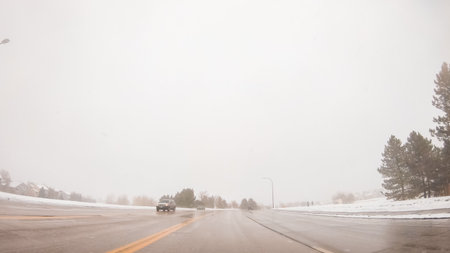Driving through typical American suburban neighborhood on a cold Winter morning.の写真素材