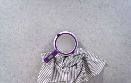 Flat lay. Melting color chocolate chips in a candy melting pot to make carrot chocolate-covered pretzels.の写真素材