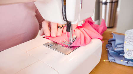 Sewing cotton face mask with a sewing machine for virus outbreak.の写真素材
