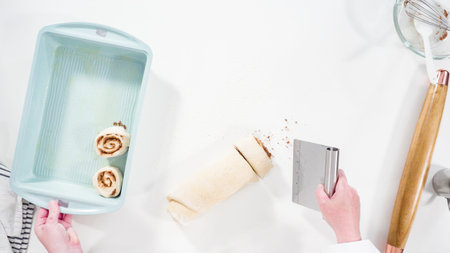 Flat lay. Rolling dough with a french rolling pin to bake cinnamon rolls.