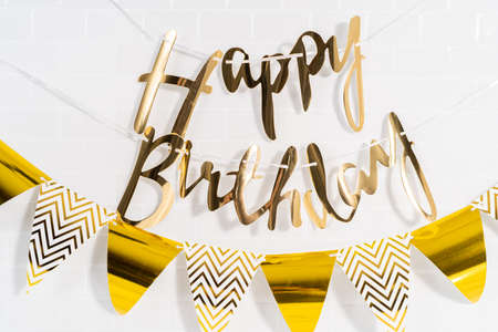 Paper Happy Birthday gold paper banner in the kitchen.の写真素材