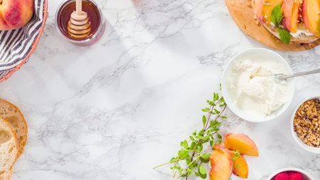 Flat lay. Step by step. Making ricotta toasts with organic peaches and berries.