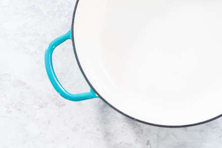 Clean cast iron enameled brassier on the kitchen counter.の写真素材