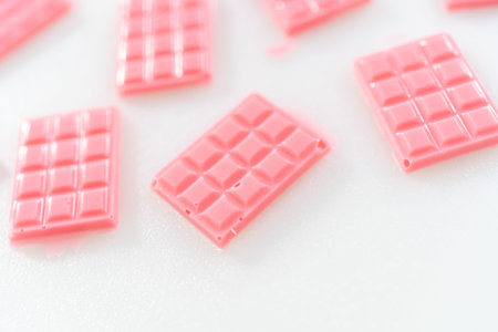 Removing mini pink chocolates from silicone chocolate mould.
