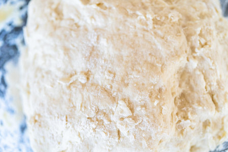 Preparing bread dough on the kitchen counter to bake flatbread.