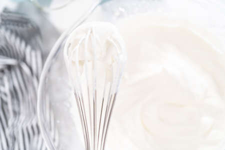 Mixing ingredients in a glass mixing bowl to make chocolate ice cream.の写真素材