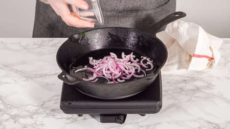 step by step. Sauteeing onion for spinach and ham frittata.の写真素材