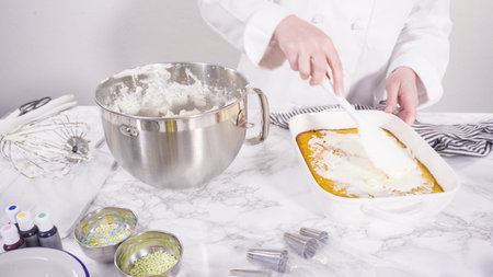 Frosting sheet cake with Italian buttercream frosting.