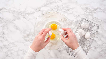 flat lay. step by step. Mixing ingredients in a glass mixing bowl for spinach and ham frittata.の写真素材