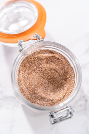 Cinnamon sugar in a glass mason jar on the marble surface.の写真素材