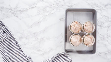 Flat lay. Step by step. Scooping homemade chocolate ice cream into glass jars.