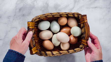 Flat lay. Colorful farm fresh eggs in vintage egg crate.の写真素材