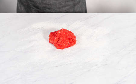 Rolling red and blue bread dough to bake patriotic cinnamon twists.の写真素材