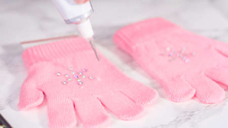 Rhinestone pink kids gloves with snowflake shapes.の写真素材