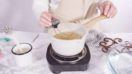 Step by step. Caramelizing sugar in a small cooking pot over the small electric stove.の写真素材