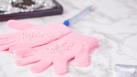 Rhinestone pink kids gloves with snowflake shapes.の写真素材