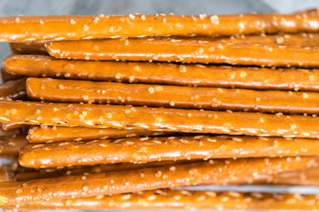 Ingredients in glass mixing bowls to prepare carrot chocolate covered pretzels.