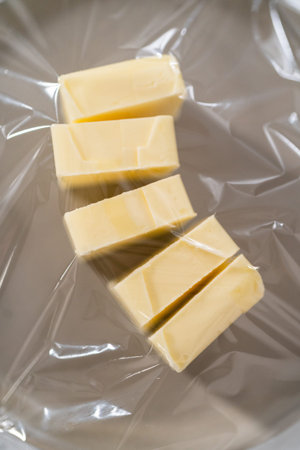 Softened sticks of unsalted butter on the kitchen counter.