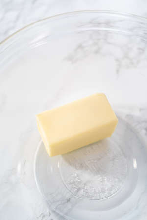 Melting stick of unsalted butter in a microwave.の写真素材