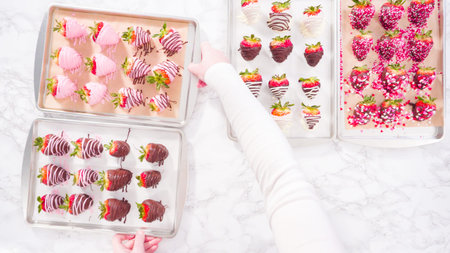 Flat lay. Step by step. Variety of chocolate dipped strawberries on a parchment paper.の写真素材
