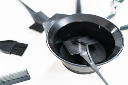 Black hair color dye kit with mixing bowl on a white background.の写真素材