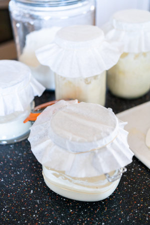 Preparing homemade sourdough starter for baking bread.