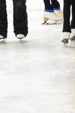View of a figure skater and her coach feet at the figure skating practice.