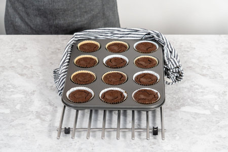 Cooling freshly baked smores cupcakes in a cupcake baking pan.